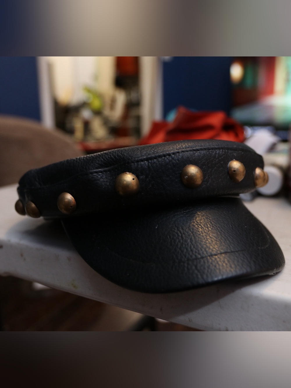 Studded Black Leather Cap with Brass Accents